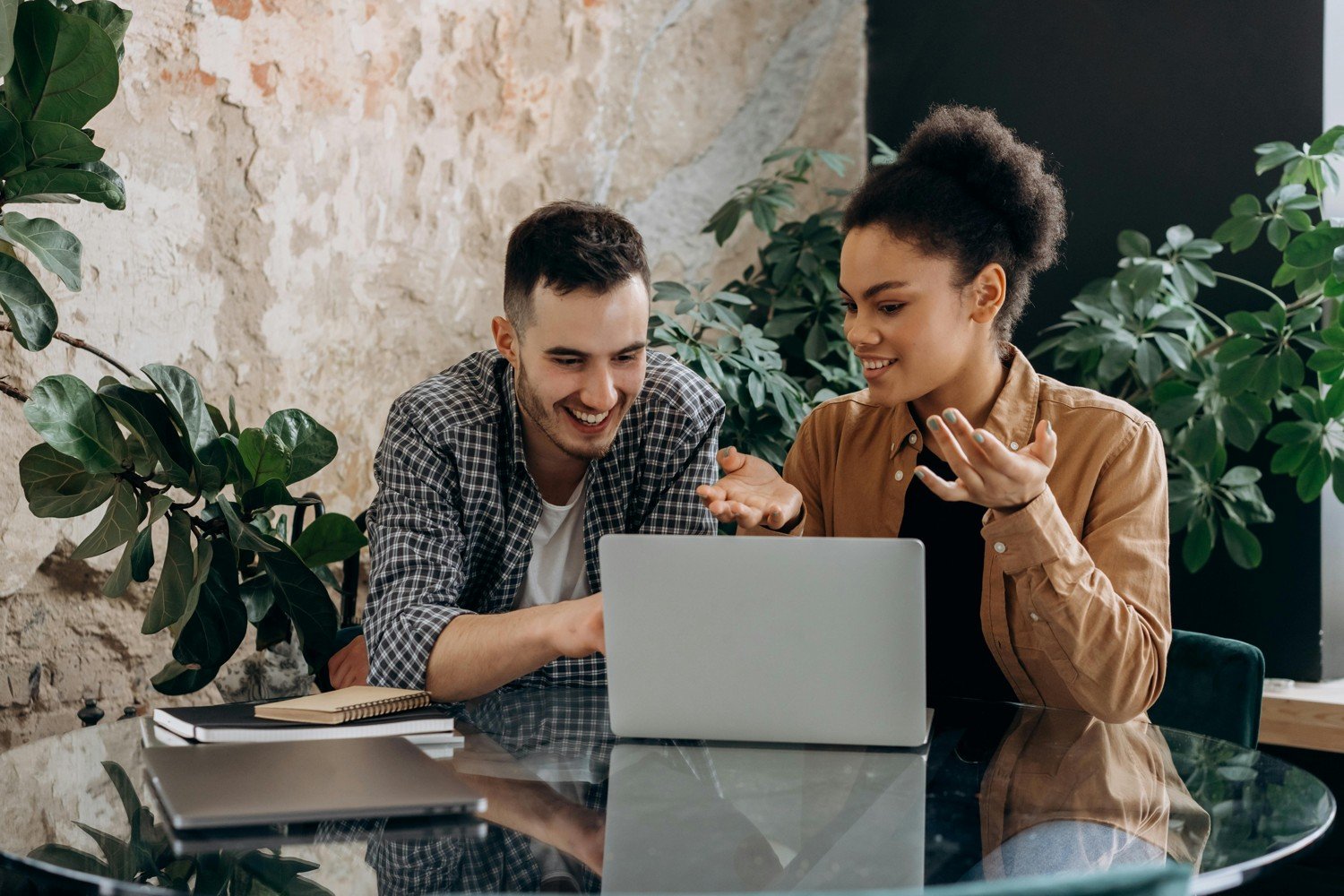 Two people reviewing information together on a laptop