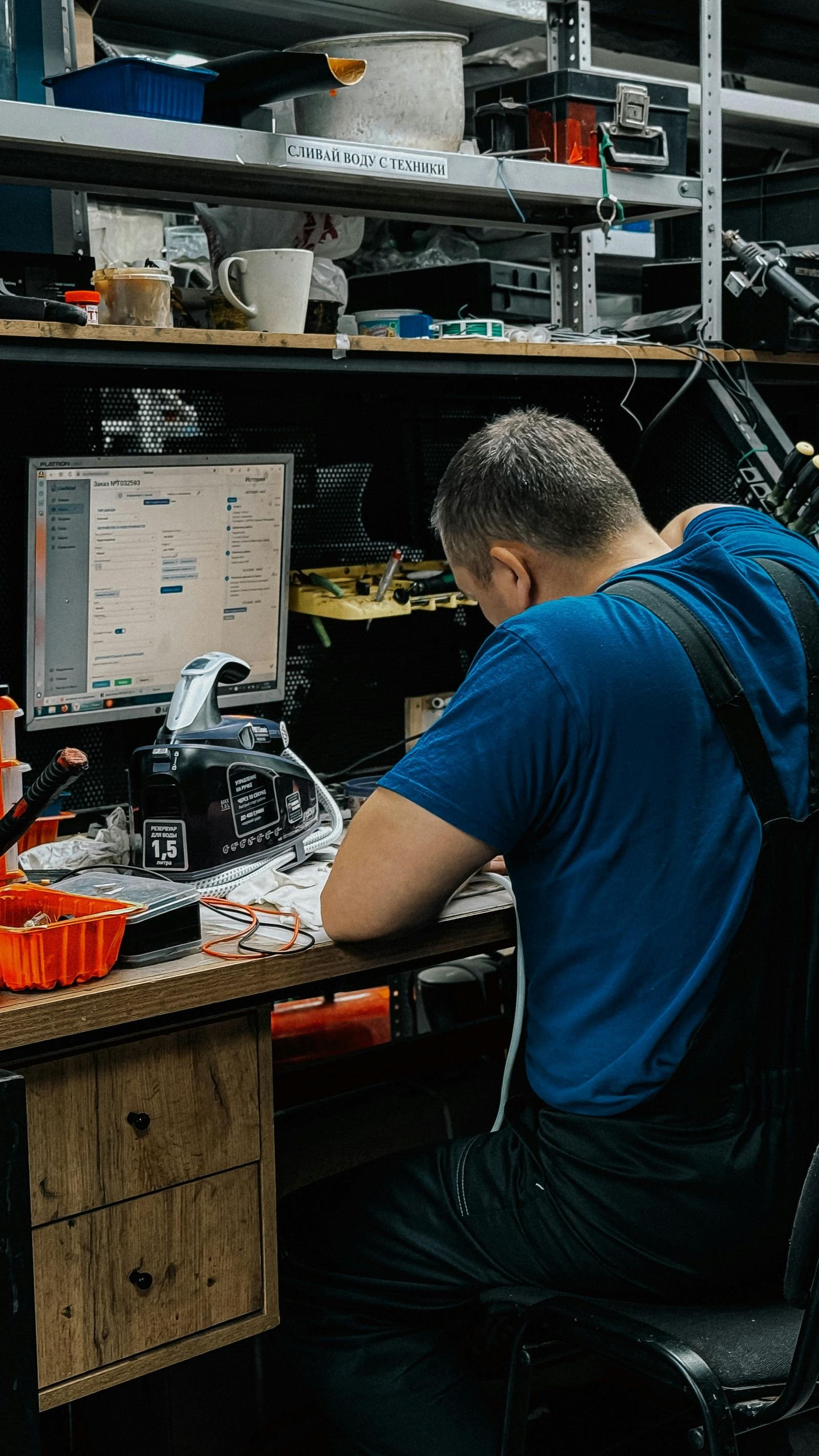 Technician working at a computer repair workbench